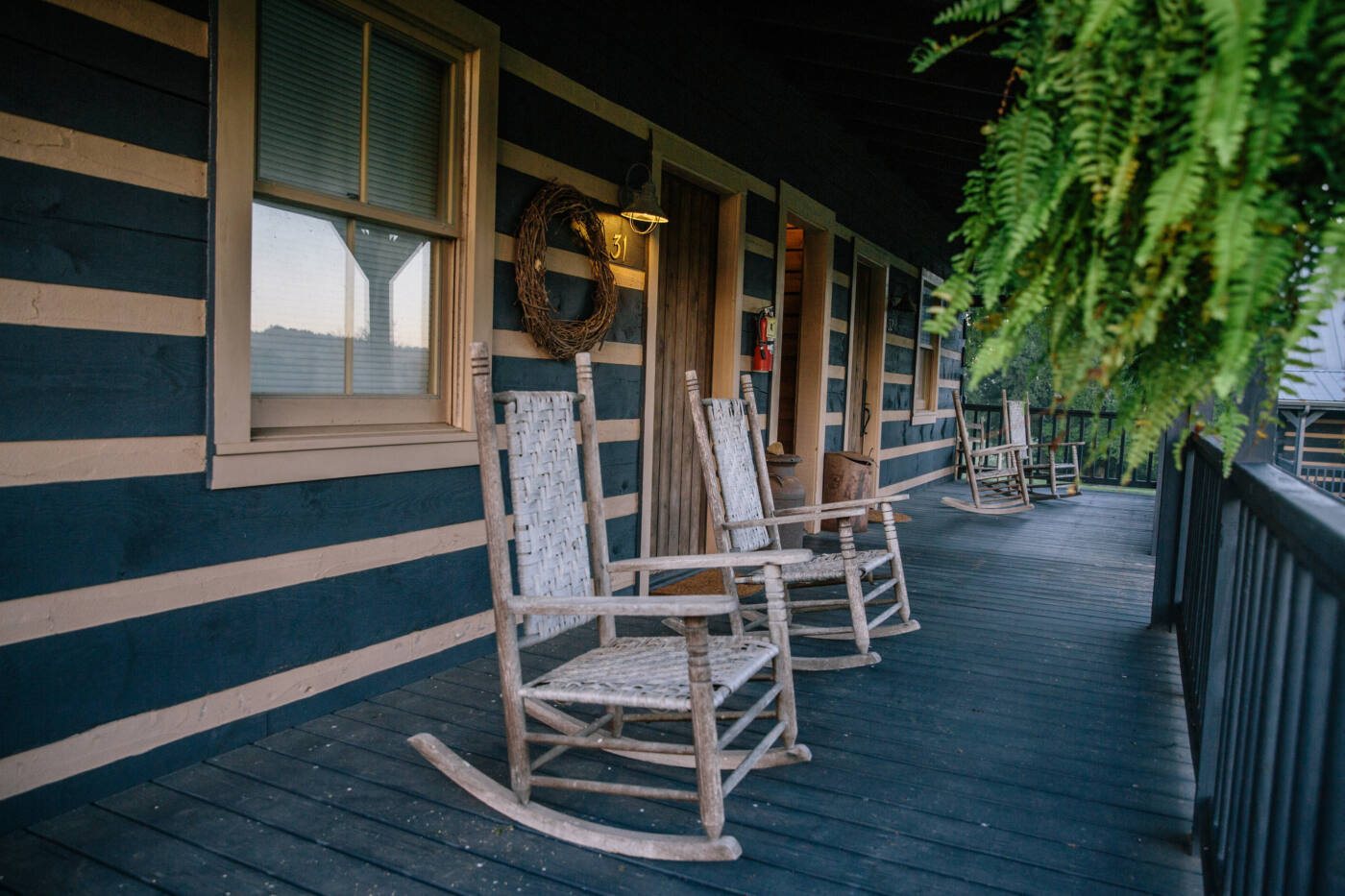 Four rocking chairs on a wooden porch