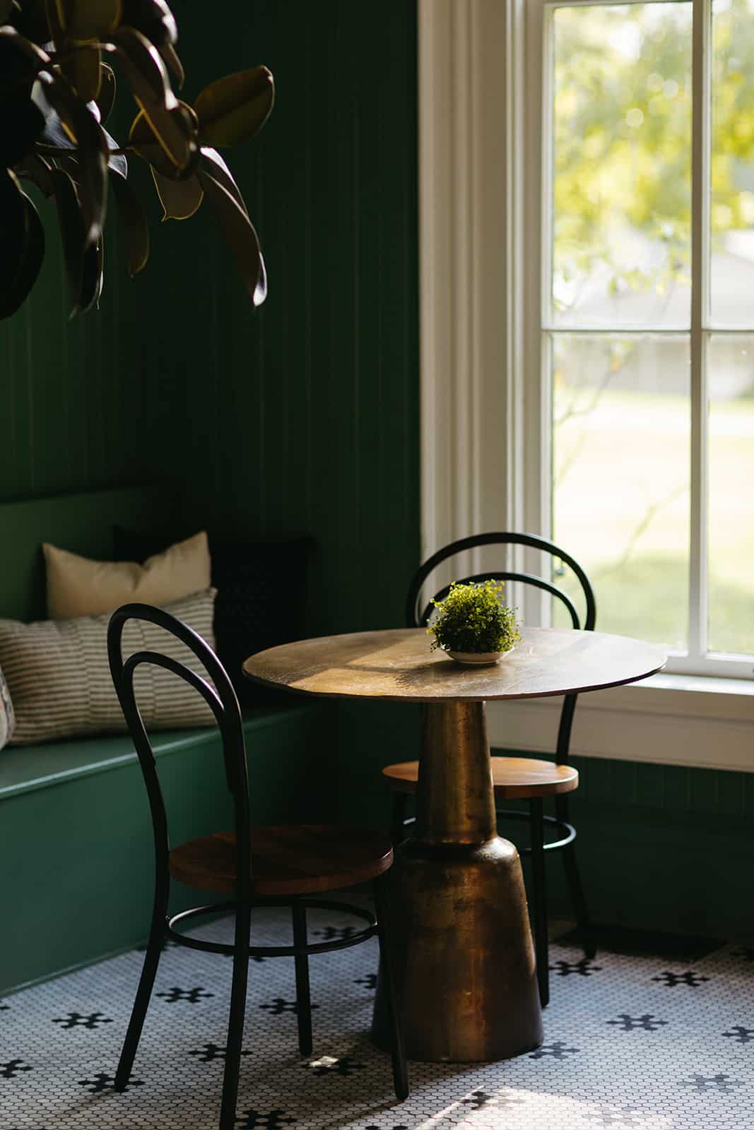 A small table and two chairs in the corner of a room