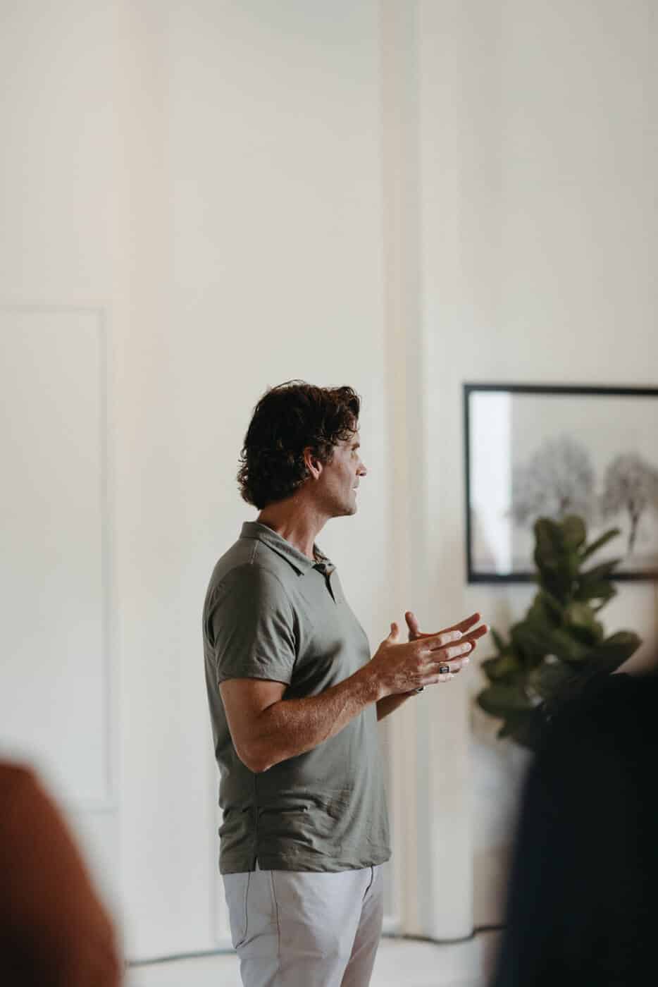 Miles Adcox speaking in front of a group of people