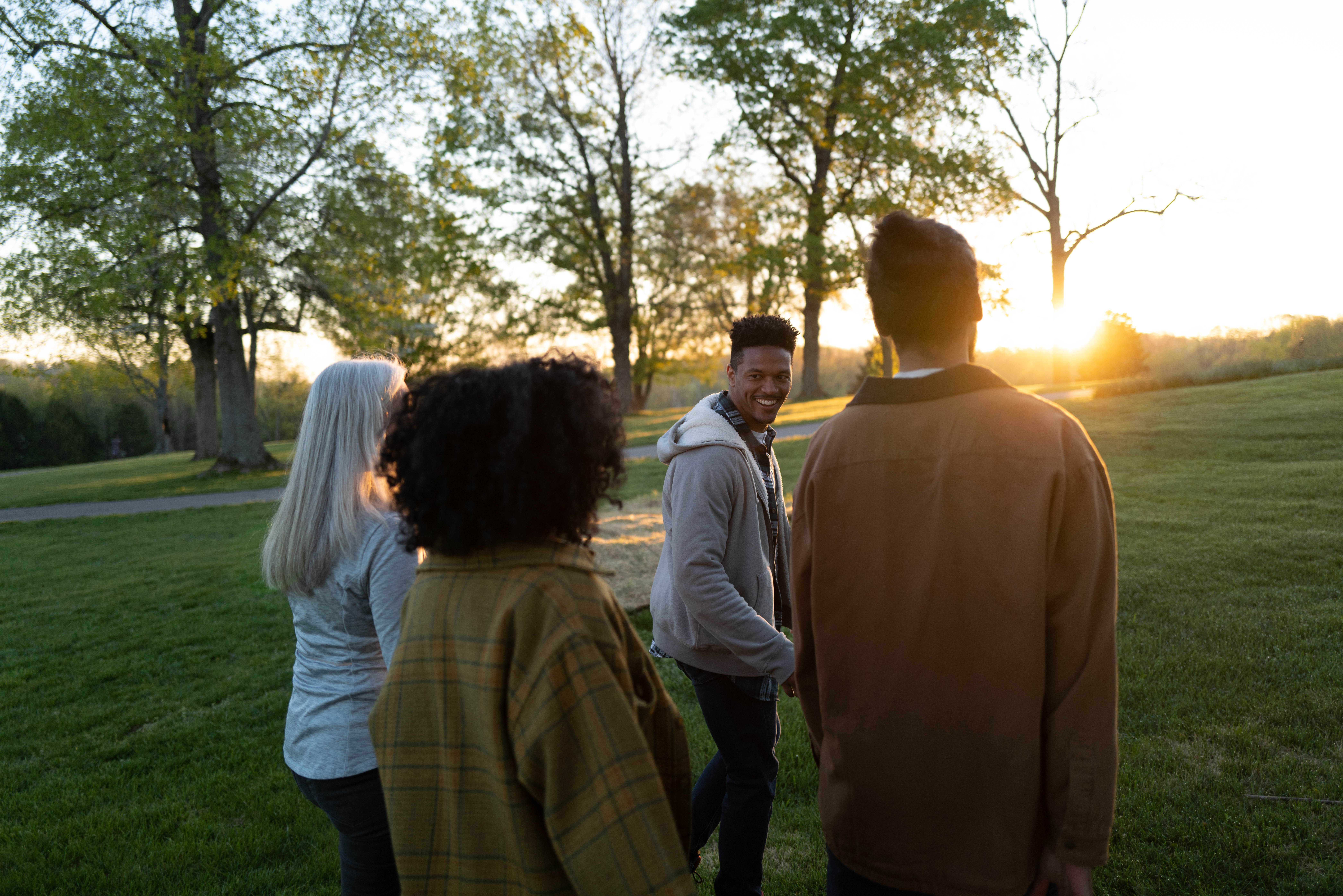 people walking into the sunset having conversations