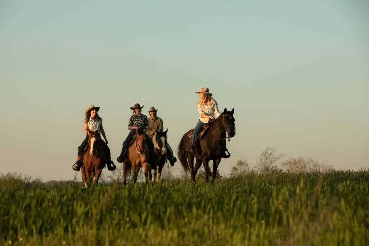 group riding horses in a field