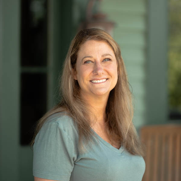 Onsite team member headshot, smiling woman, emotional wellness advocate