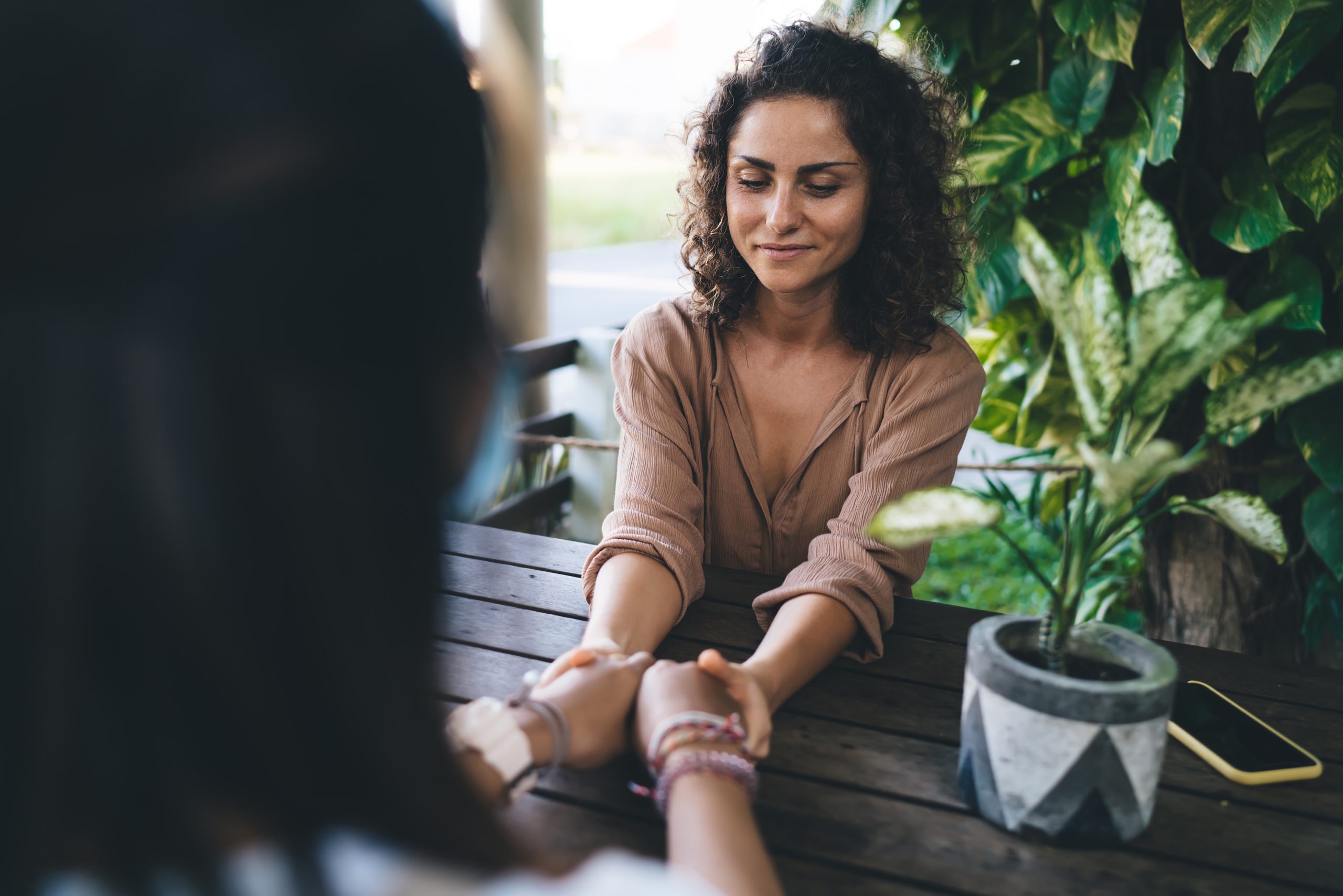 Banner image of two women holding hands.